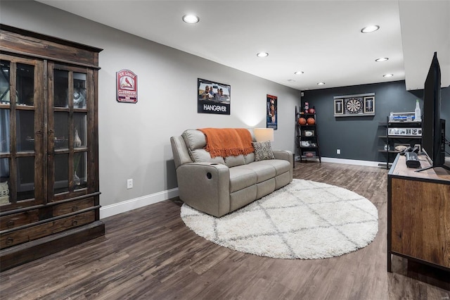 living area with recessed lighting, baseboards, and wood finished floors