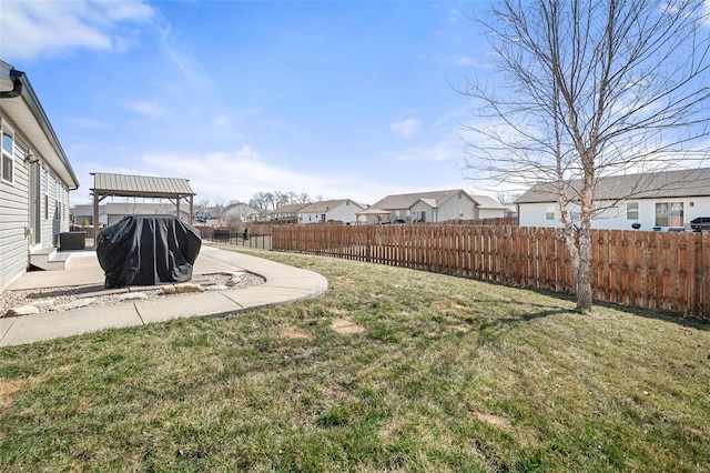 view of yard with a residential view, a patio, and fence