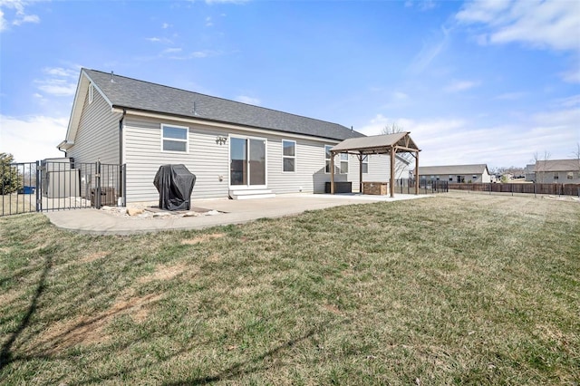 back of property with a gazebo, a yard, a patio area, and fence