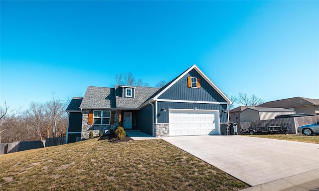 view of front of home featuring fence, a front yard, a garage, stone siding, and driveway