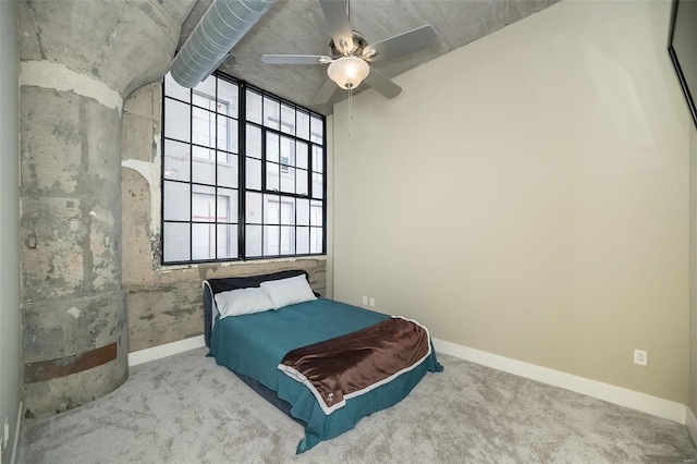 bedroom with a ceiling fan, baseboards, and carpet floors