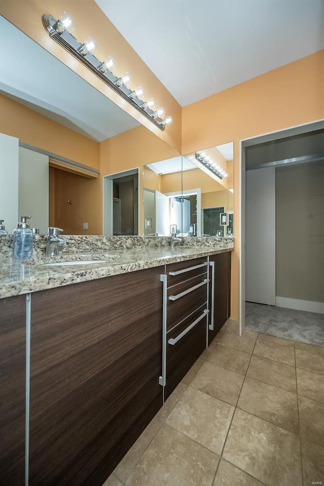 full bath featuring vanity and tile patterned flooring