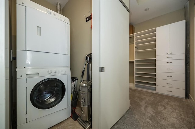 washroom with laundry area, light colored carpet, and stacked washer and clothes dryer