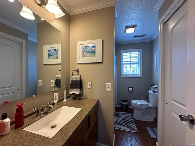 full bathroom with visible vents, vanity, toilet, and crown molding