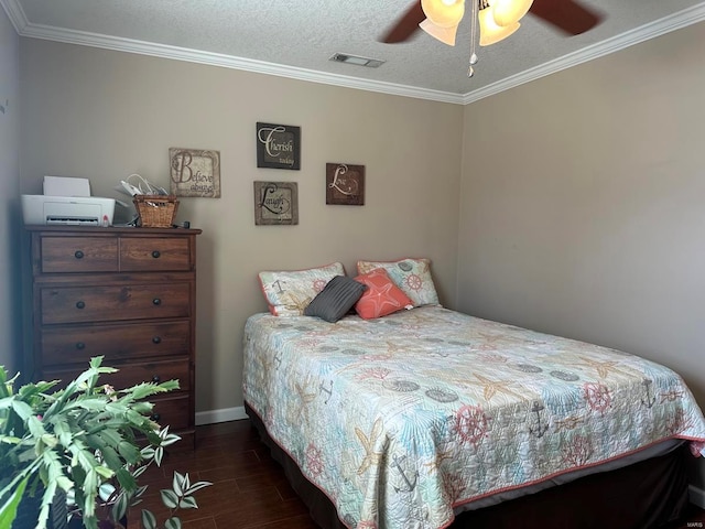 bedroom featuring visible vents, a textured ceiling, wood finished floors, and ornamental molding