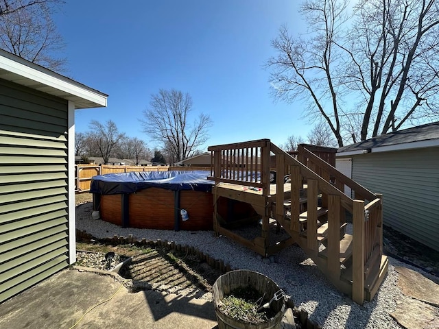 view of patio featuring a fenced in pool, a wooden deck, stairs, and fence