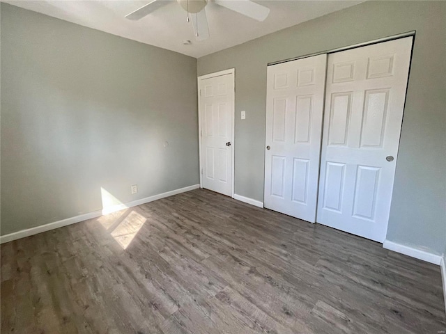 unfurnished bedroom featuring a closet, ceiling fan, baseboards, and wood finished floors