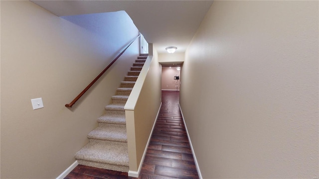 stairway featuring wood finished floors and baseboards