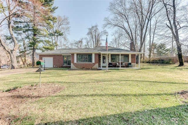 view of front of property featuring brick siding, an attached garage, a chimney, and a front yard