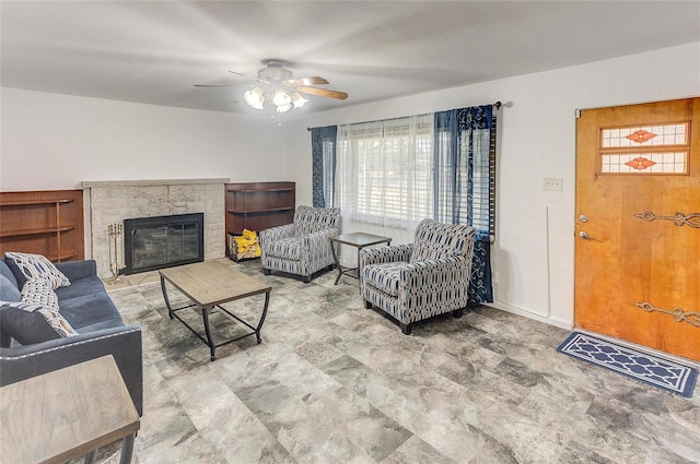 living room featuring a glass covered fireplace, plenty of natural light, and a ceiling fan