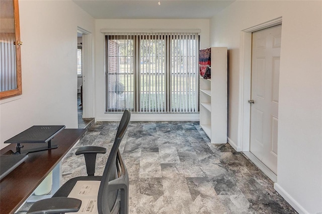 interior space with stone finish floor and baseboards