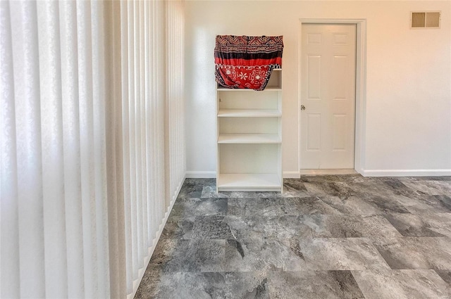 unfurnished room featuring visible vents and baseboards