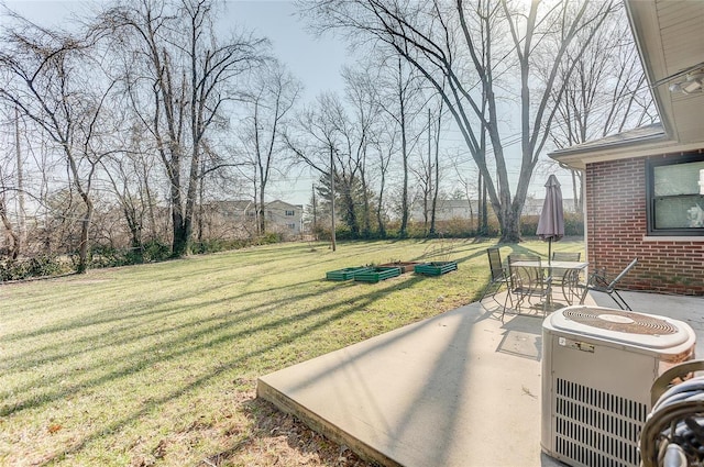 view of yard featuring central air condition unit and a patio