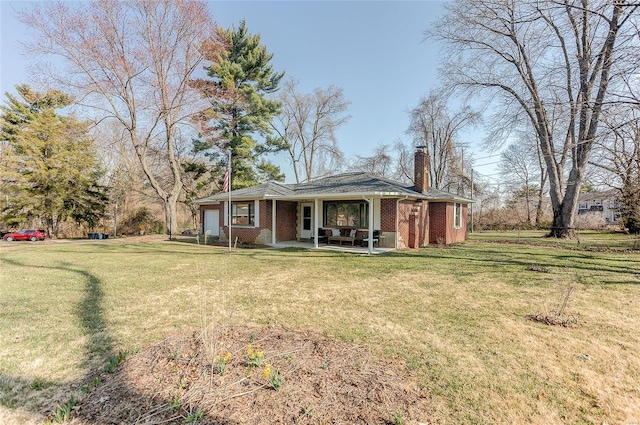 exterior space featuring brick siding, a lawn, a porch, and a chimney