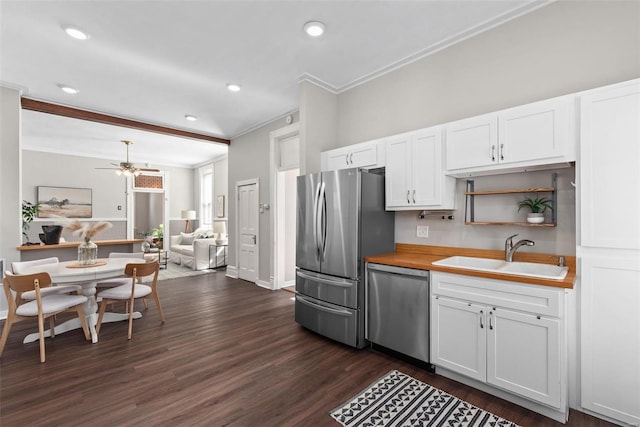 kitchen with dark wood-type flooring, a sink, open shelves, stainless steel appliances, and white cabinets