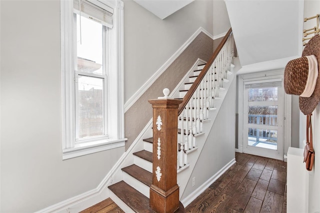 stairway featuring baseboards and wood finished floors