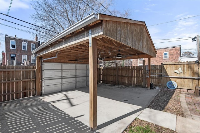 exterior space with a carport, an outbuilding, a garage, and fence