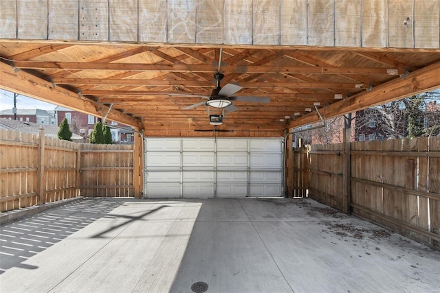 garage featuring a garage door opener and fence