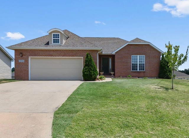 view of front of home featuring brick siding, a front lawn, concrete driveway, roof with shingles, and an attached garage