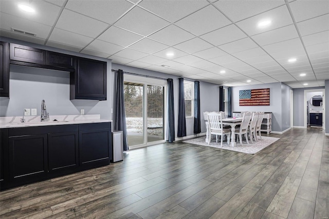 dining room featuring dark wood-style floors, visible vents, baseboards, recessed lighting, and a drop ceiling