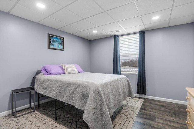 bedroom featuring visible vents, baseboards, recessed lighting, wood finished floors, and a paneled ceiling