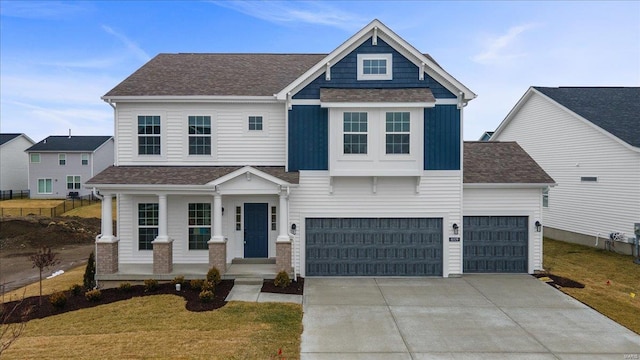 craftsman-style house featuring board and batten siding, a front lawn, roof with shingles, and driveway