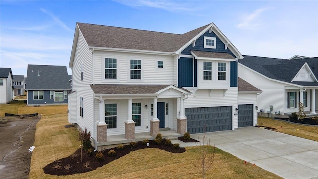 view of front of home with covered porch, concrete driveway, an attached garage, and a shingled roof