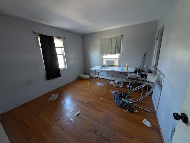 interior space with cooling unit and hardwood / wood-style flooring