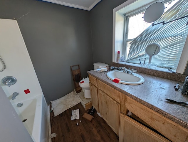 full bathroom with toilet, wood finished floors, vanity, and crown molding