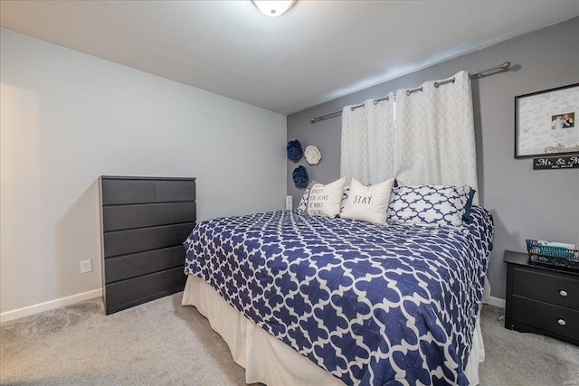 bedroom featuring baseboards and carpet