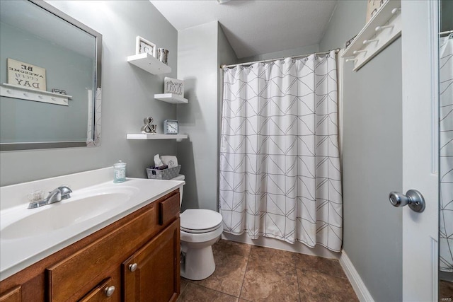 full bath with toilet, vanity, and baseboards