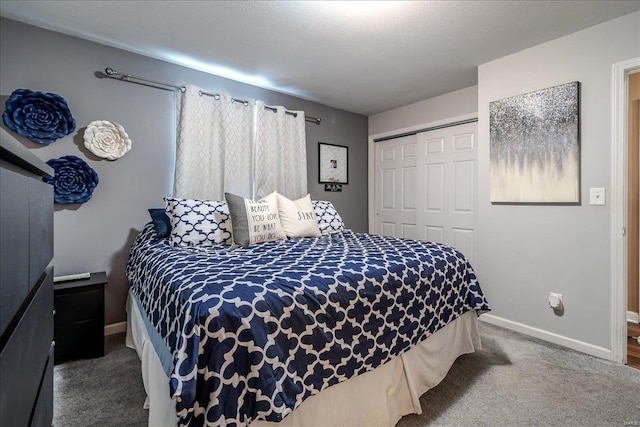 bedroom with carpet, baseboards, and a closet