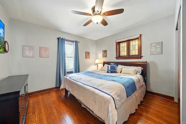 bedroom with baseboards, ceiling fan, and dark wood-style flooring