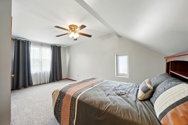 carpeted bedroom featuring lofted ceiling, a ceiling fan, and multiple windows