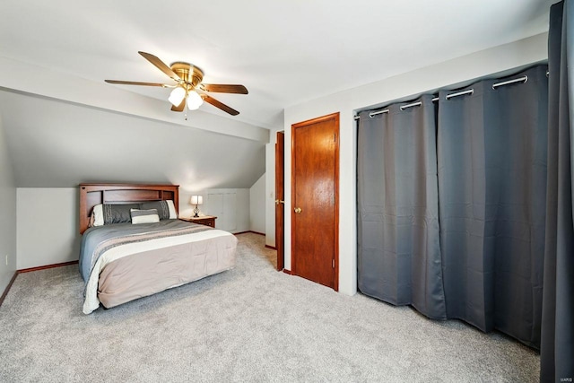 carpeted bedroom featuring baseboards, ceiling fan, and vaulted ceiling