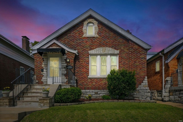 view of front of house with brick siding and a front yard