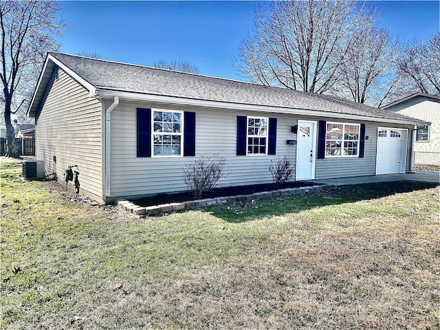 ranch-style home featuring central air condition unit, a front lawn, and a garage