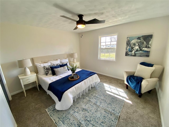 carpeted bedroom with ceiling fan and baseboards