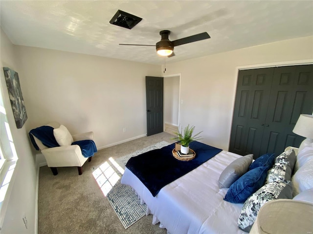 carpeted bedroom featuring baseboards, a closet, and ceiling fan