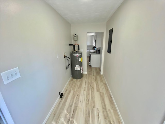 utility room featuring water heater and electric panel