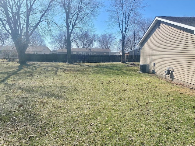 view of yard featuring cooling unit and fence