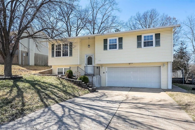 bi-level home featuring concrete driveway and a garage