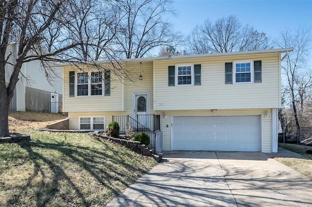 bi-level home with an attached garage and concrete driveway