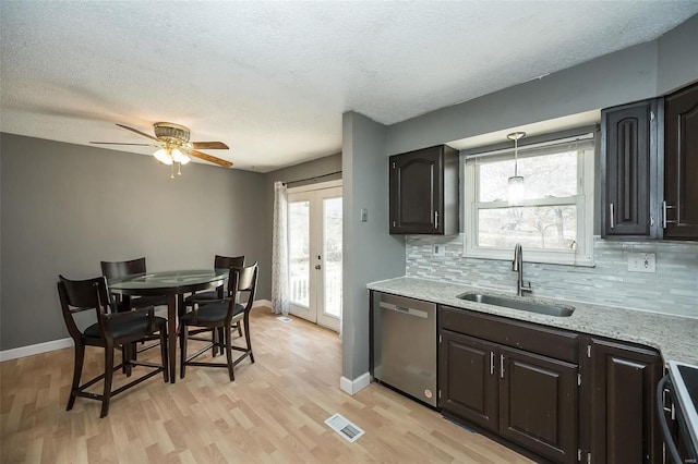 kitchen featuring visible vents, a sink, french doors, stove, and dishwasher