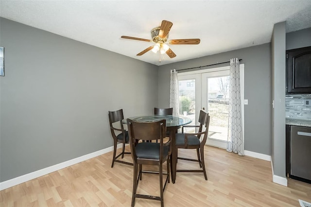 dining area featuring french doors, light wood-type flooring, and baseboards