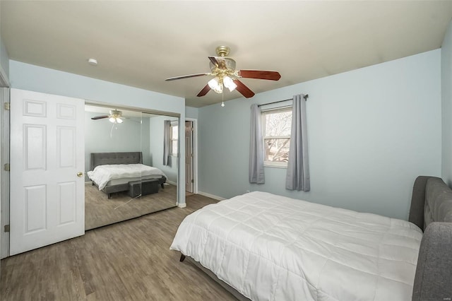 bedroom featuring a ceiling fan, wood finished floors, and a closet