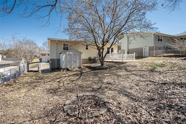 view of yard featuring an outbuilding, a storage unit, and fence private yard