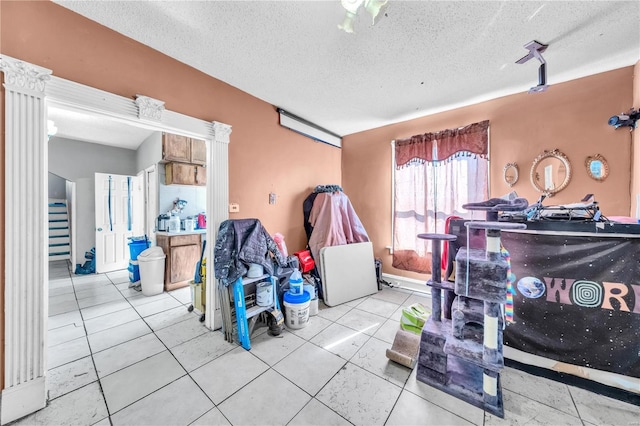 miscellaneous room featuring tile patterned floors and a textured ceiling