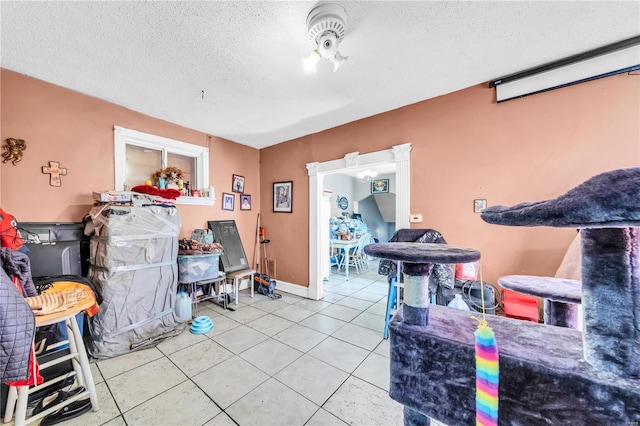 interior space with tile patterned flooring and a textured ceiling