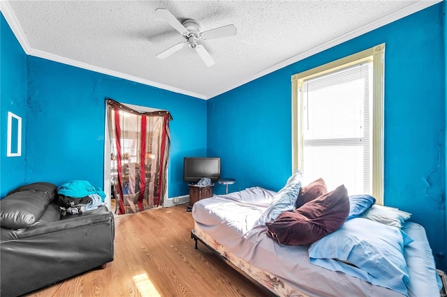 bedroom featuring crown molding, multiple windows, and wood finished floors